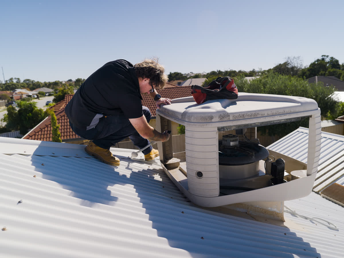 A Westplumb technician servicing an open evap unit